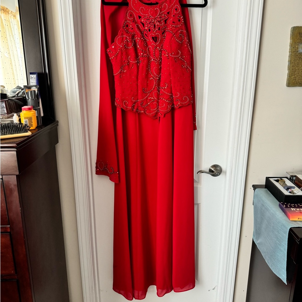 Red halter gown with beads and sequins.